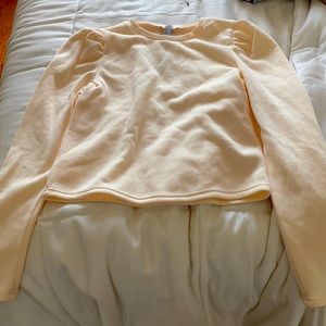 Cream colored sweatshirt with ruched sleeve seam